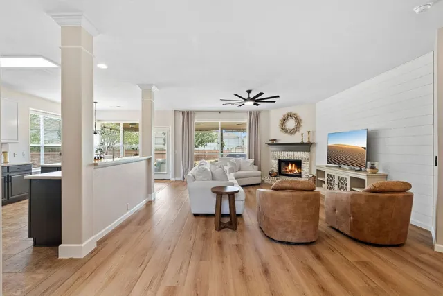 a living room with fireplace furniture and a wooden floor