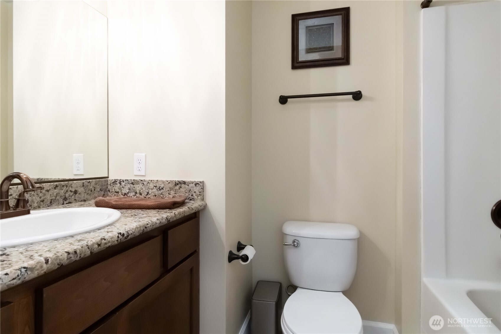 6721 Southeast 2nd Street Renton, WA 98059 - Photo 14 of 32 a bathroom with a granite countertop toilet sink and mirror