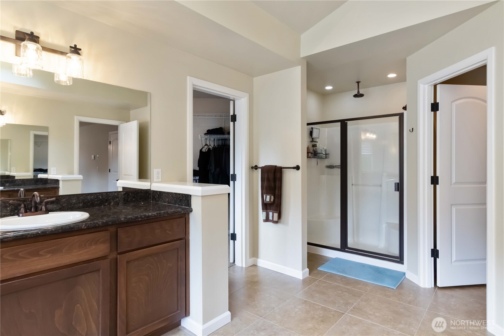 6721 Southeast 2nd Street Renton, WA 98059 - Photo 18 of 32 a bathroom with a granite countertop sink shower and a mirror