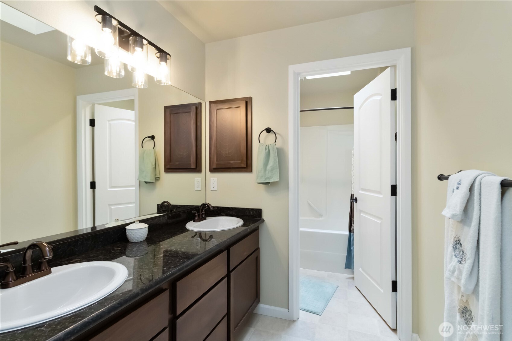 6721 Southeast 2nd Street Renton, WA 98059 - Photo 22 of 32 a bathroom with a granite countertop sink shower and a mirror