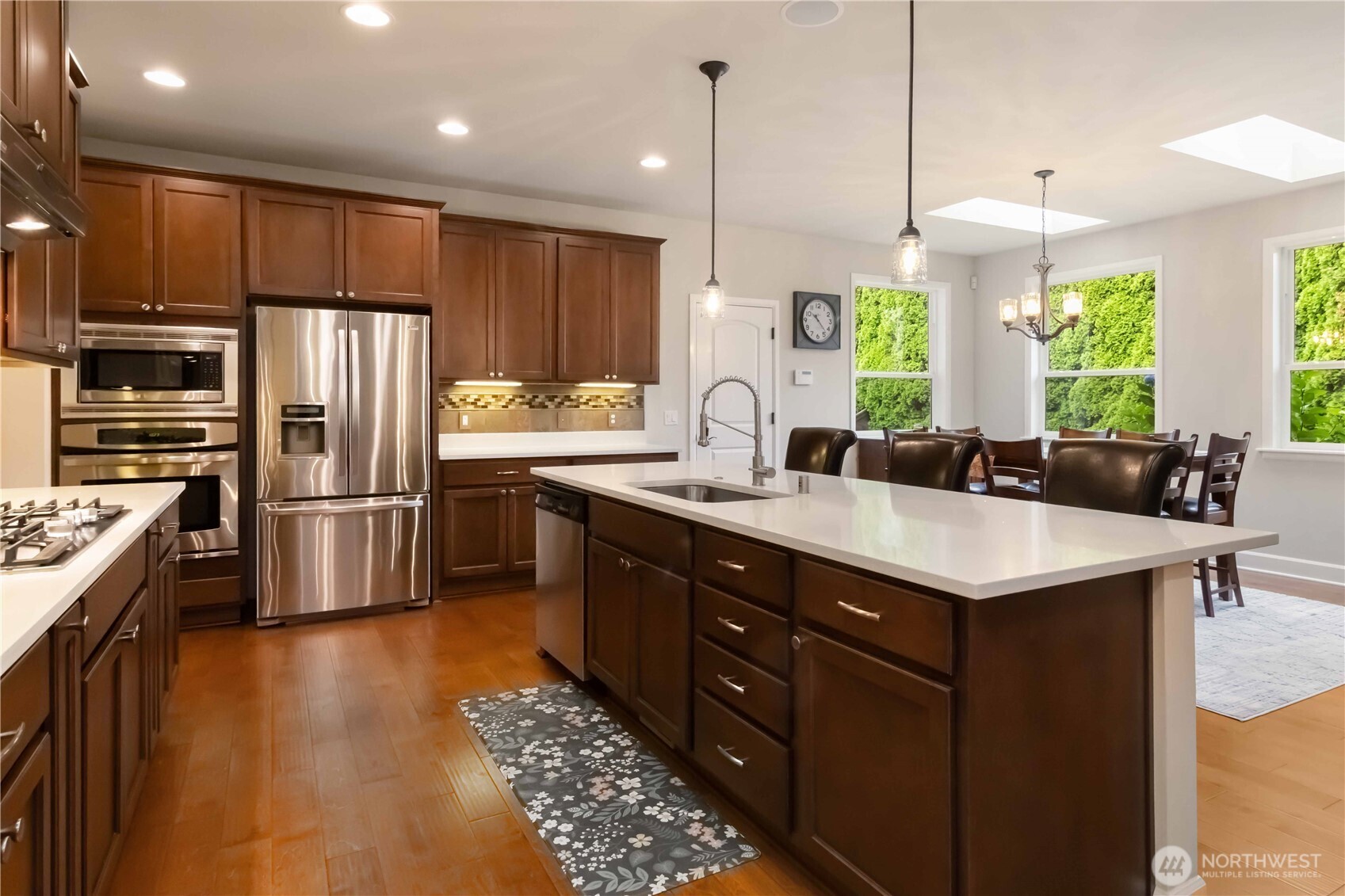 6721 Southeast 2nd Street Renton, WA 98059 - Photo 8 of 32 a kitchen with stainless steel appliances granite countertop a sink a stove and a refrigerator