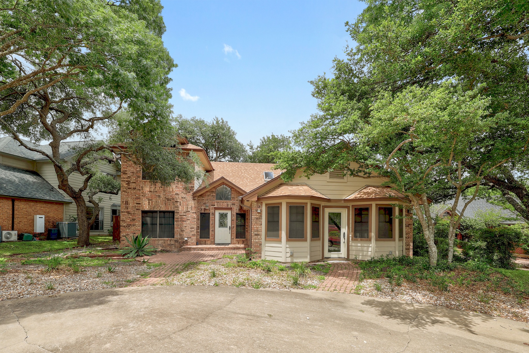 2202 Warfield Way Austin, TX 78728 - Photo 1 of 32 A charming exterior with a blend of brick and siding, framed by mature shade trees.
