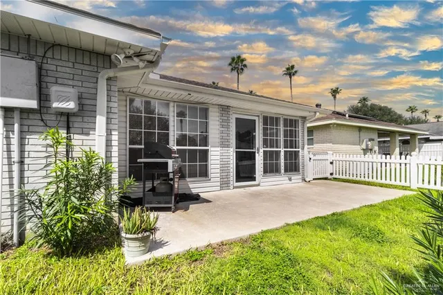 a front view of a house with a garden and patio
