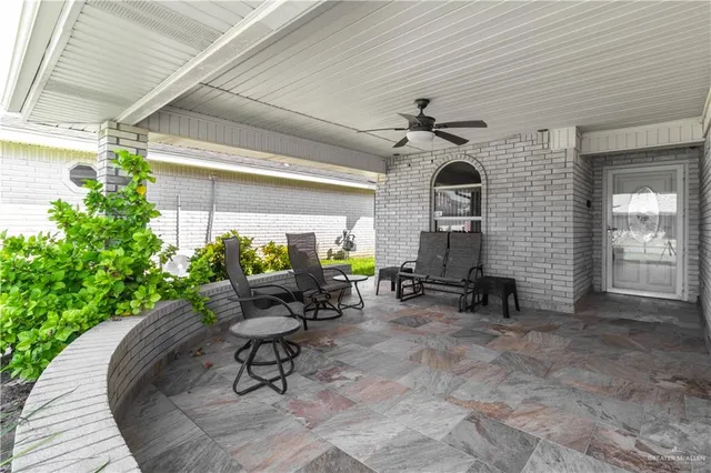 a living room filled with furniture and a potted plant