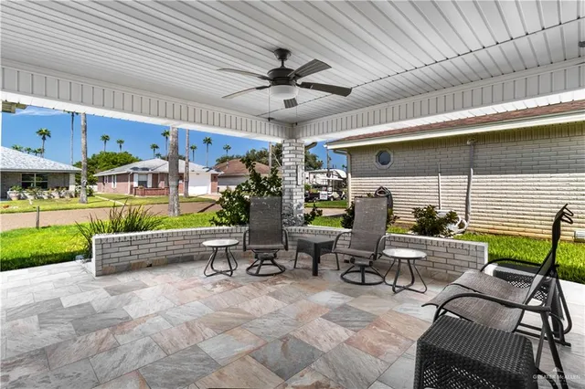 a view of a patio with a table and chairs
