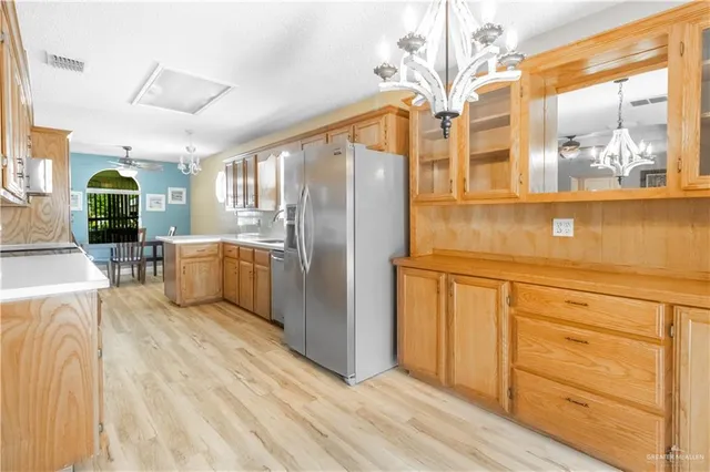 a kitchen with stainless steel appliances a refrigerator and cabinets