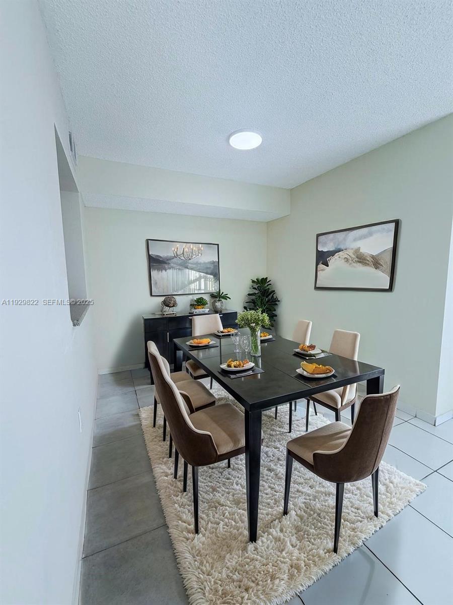 2055 Southwest 122nd Avenue, Unit 415 Miami, FL 33175 - Photo 3 of 13 a view of a livingroom with furniture and a wooden floor