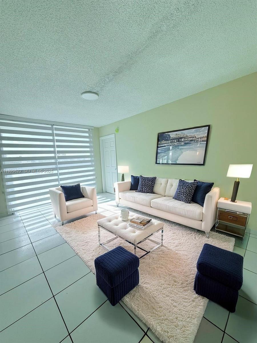 2055 Southwest 122nd Avenue, Unit 415 Miami, FL 33175 - Photo 4 of 13 a living room with furniture and a fireplace