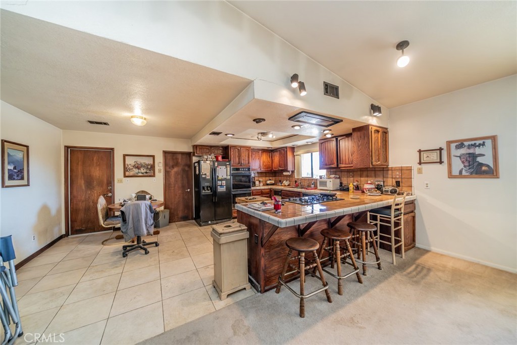 18080 Manitou Road Apple Valley, CA 92307 - Photo 12 of 43 a room with lots of chairs and mirrors