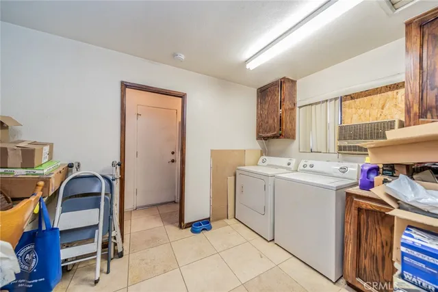 a view of a kitchen with fridge and window