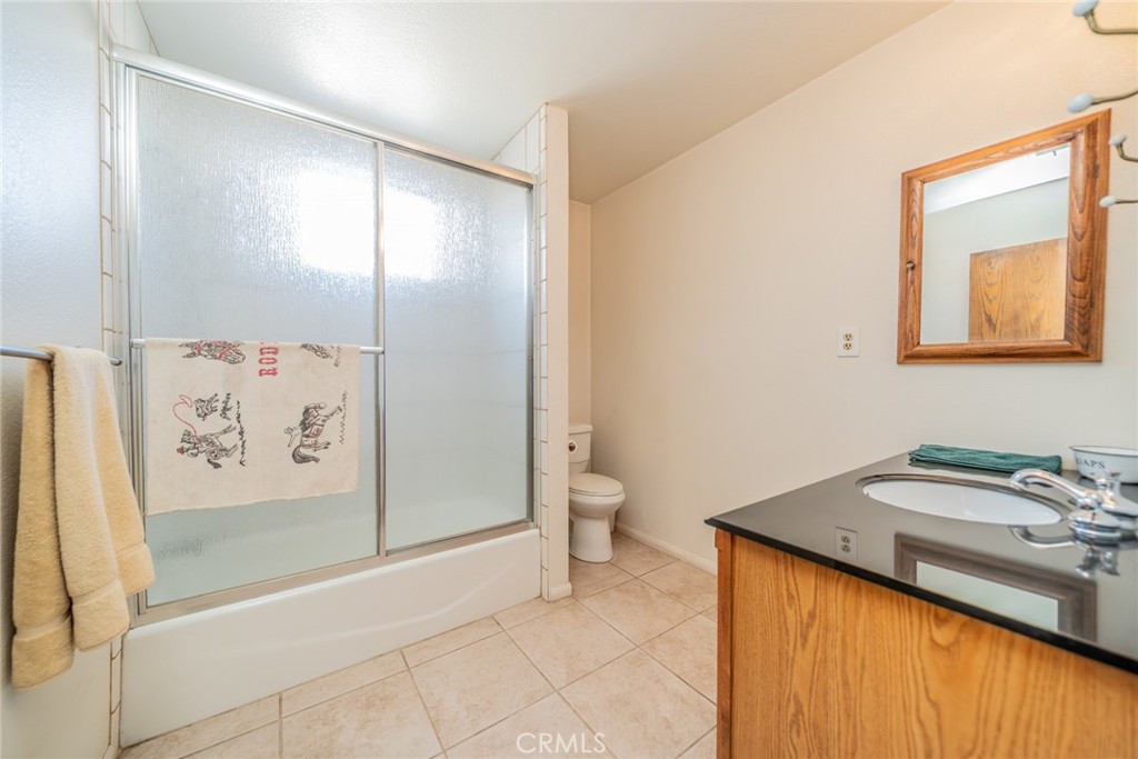18080 Manitou Road Apple Valley, CA 92307 - Photo 23 of 43 a bathroom with a sink and mirror