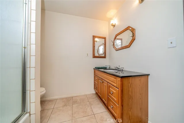 a view of a bathroom with mirror and a sink
