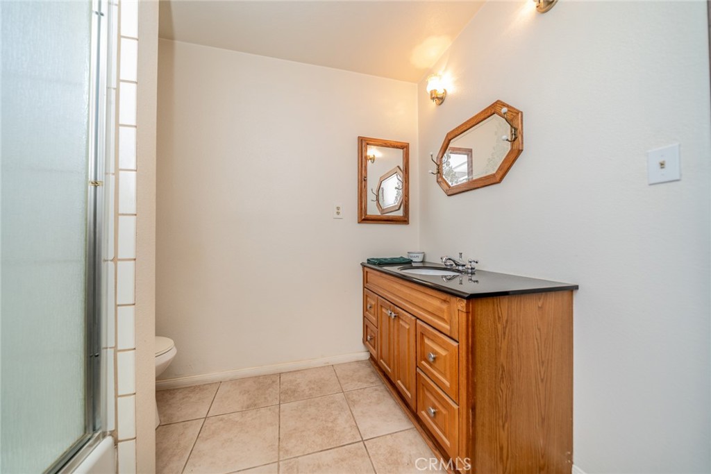 18080 Manitou Road Apple Valley, CA 92307 - Photo 24 of 43 a view of a bathroom with mirror and a sink