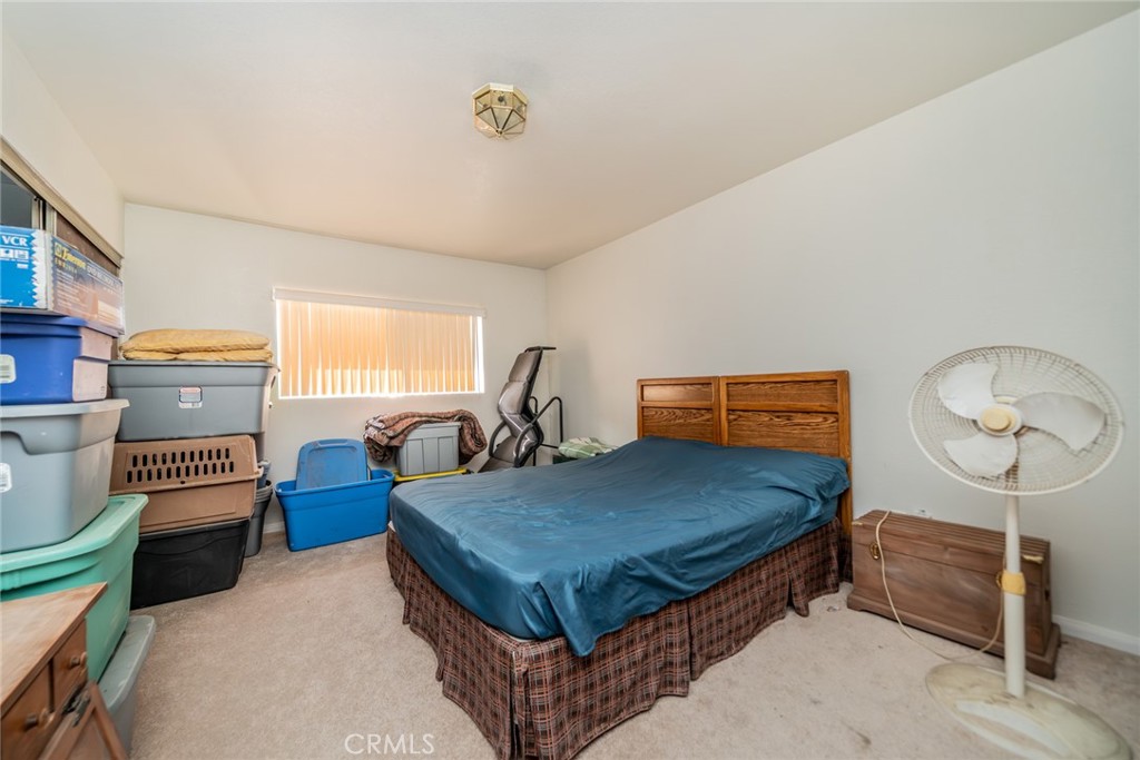 18080 Manitou Road Apple Valley, CA 92307 - Photo 25 of 43 a bed sitting in a room next to a window