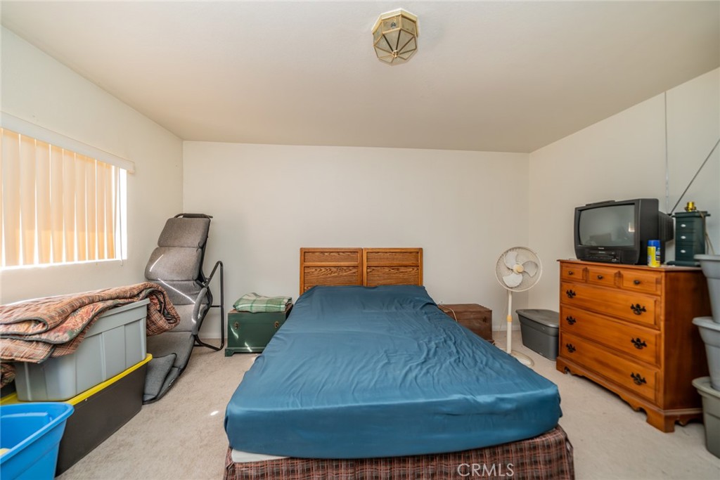 18080 Manitou Road Apple Valley, CA 92307 - Photo 26 of 43 a living room with furniture and a flat screen tv