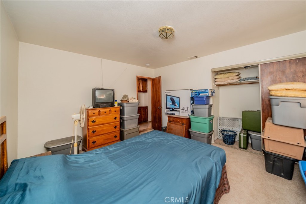 18080 Manitou Road Apple Valley, CA 92307 - Photo 27 of 43 a bedroom with a bed and wooden floor