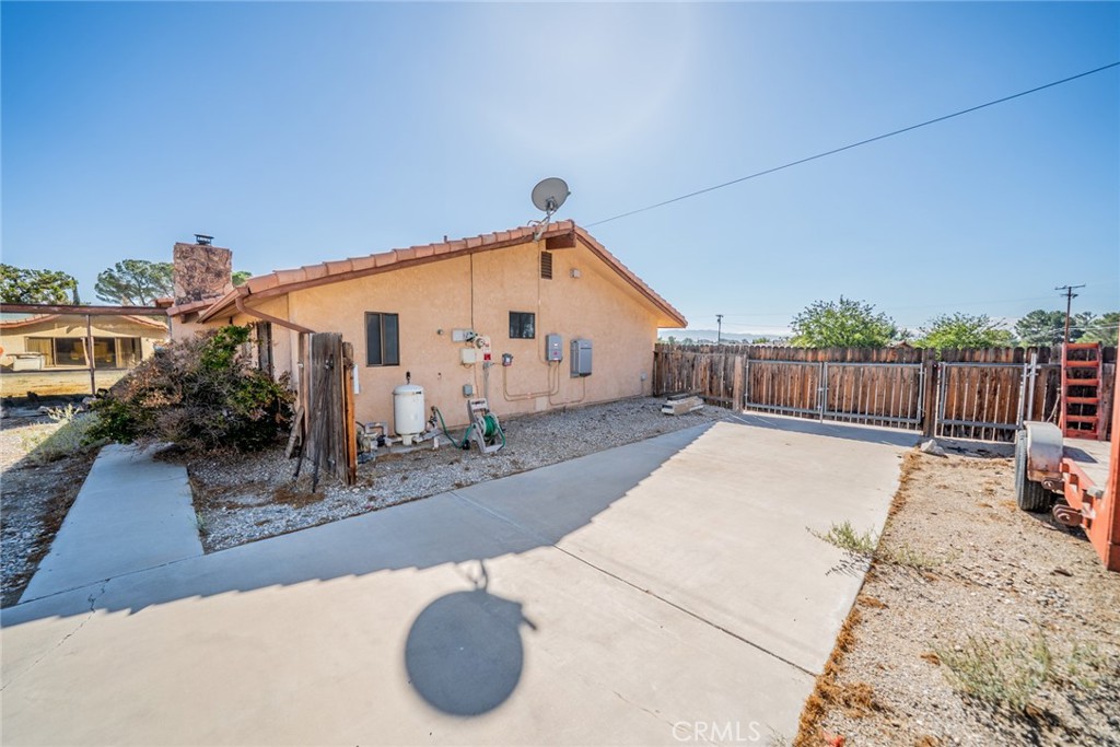 18080 Manitou Road Apple Valley, CA 92307 - Photo 32 of 43 a view of a house with backyard and sitting area