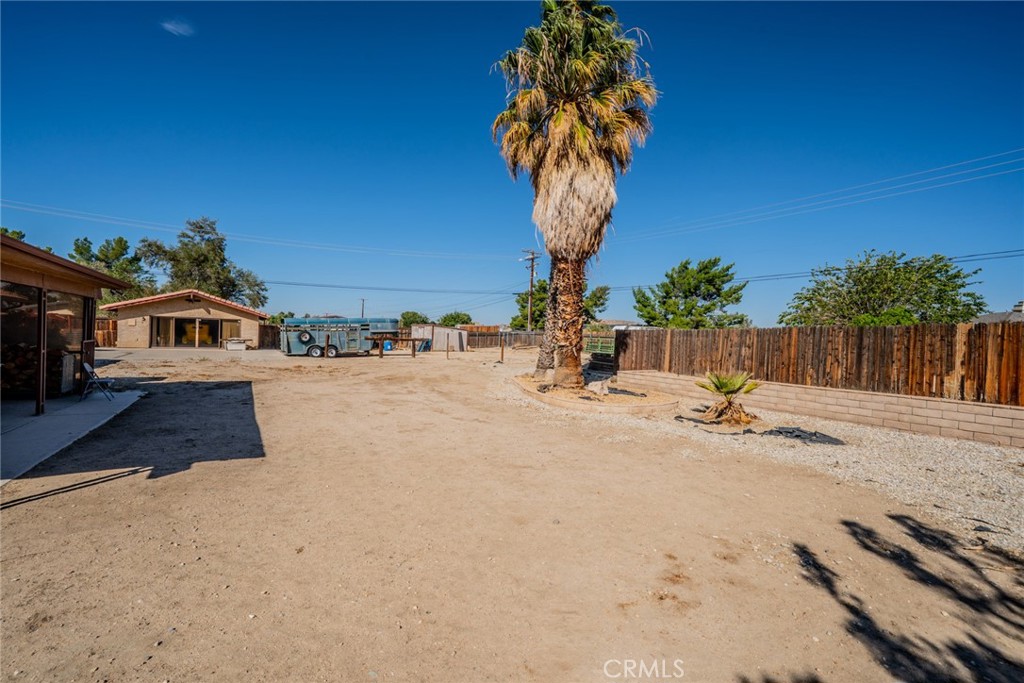 18080 Manitou Road Apple Valley, CA 92307 - Photo 37 of 43 a view of a house with backyard and tree