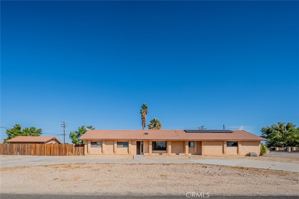 18080 Manitou Road Apple Valley, CA 92307 - Photo 5 of 43 a front view of a house with a yard