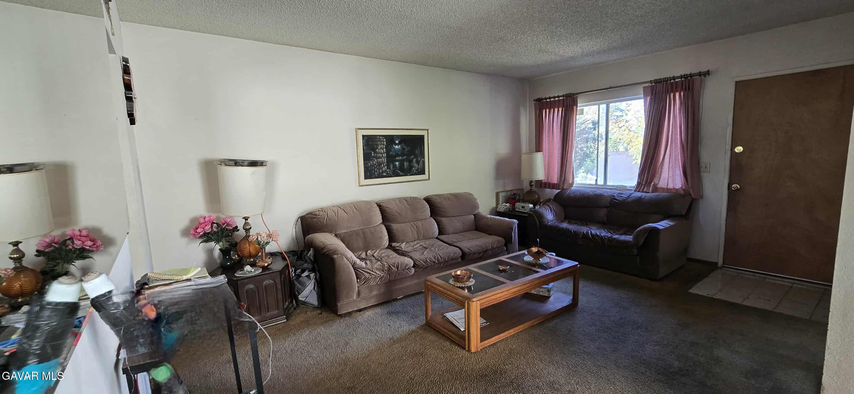 3102 Ave Q-13 Palmdale, CA 93550 - Photo 2 of 10 a living room with furniture a window and a couch