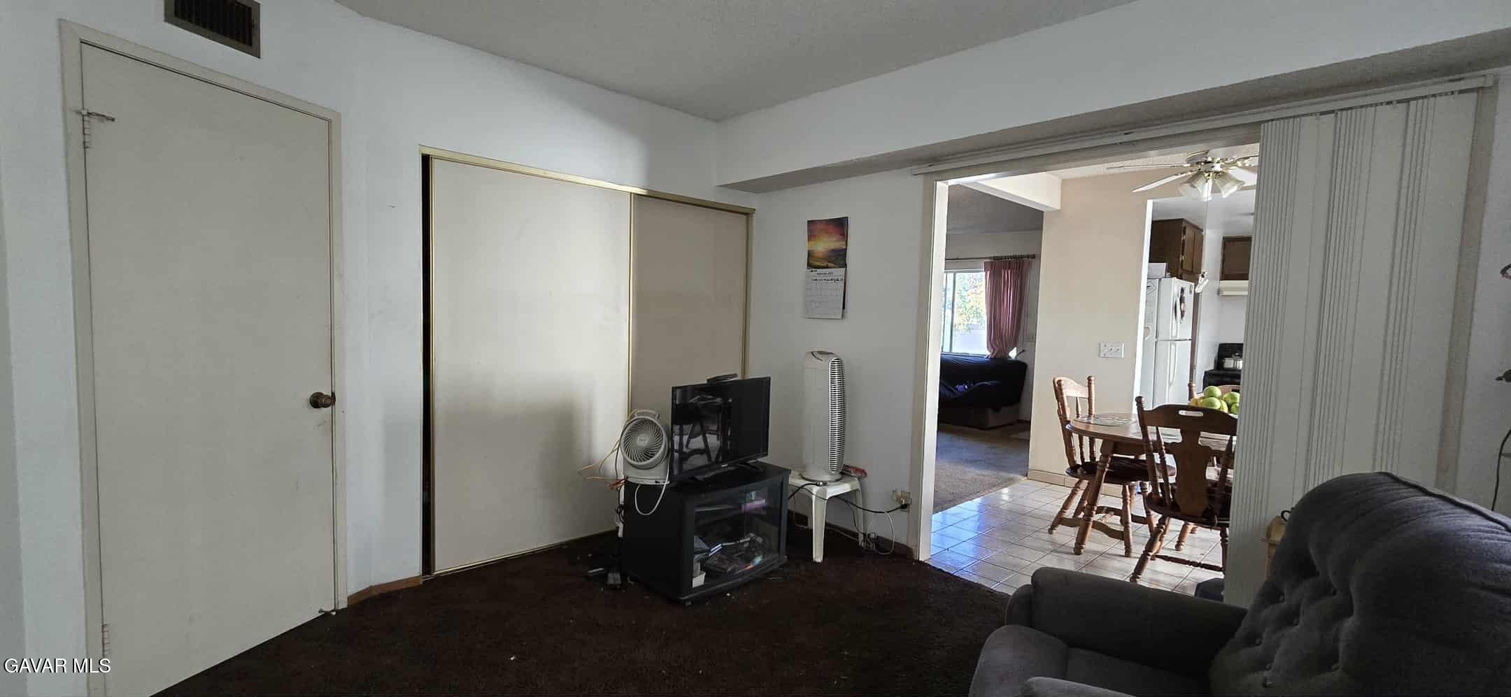 3102 Ave Q-13 Palmdale, CA 93550 - Photo 5 of 10 a living room with furniture and a flat screen tv