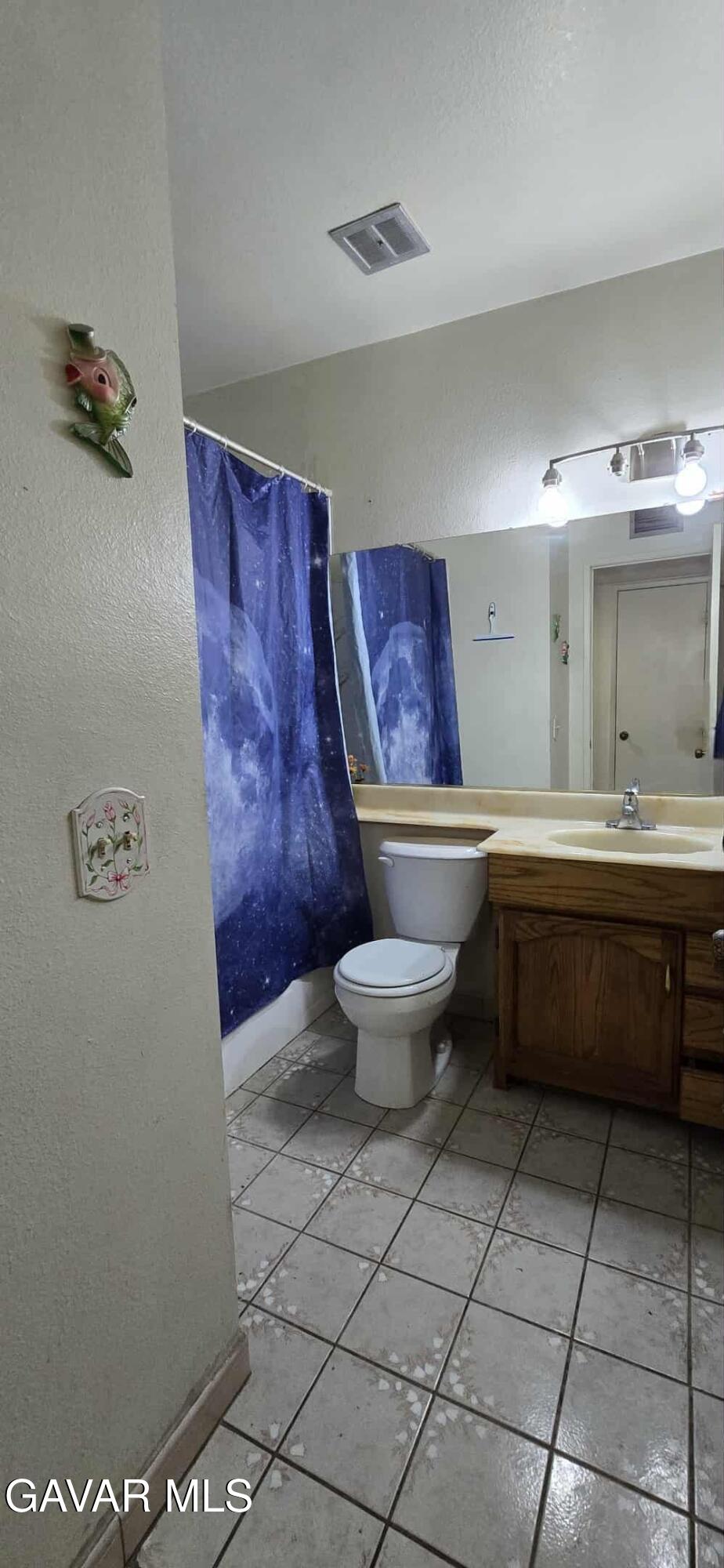 3102 Ave Q-13 Palmdale, CA 93550 - Photo 10 of 10 a bathroom with a toilet a sink and mirror