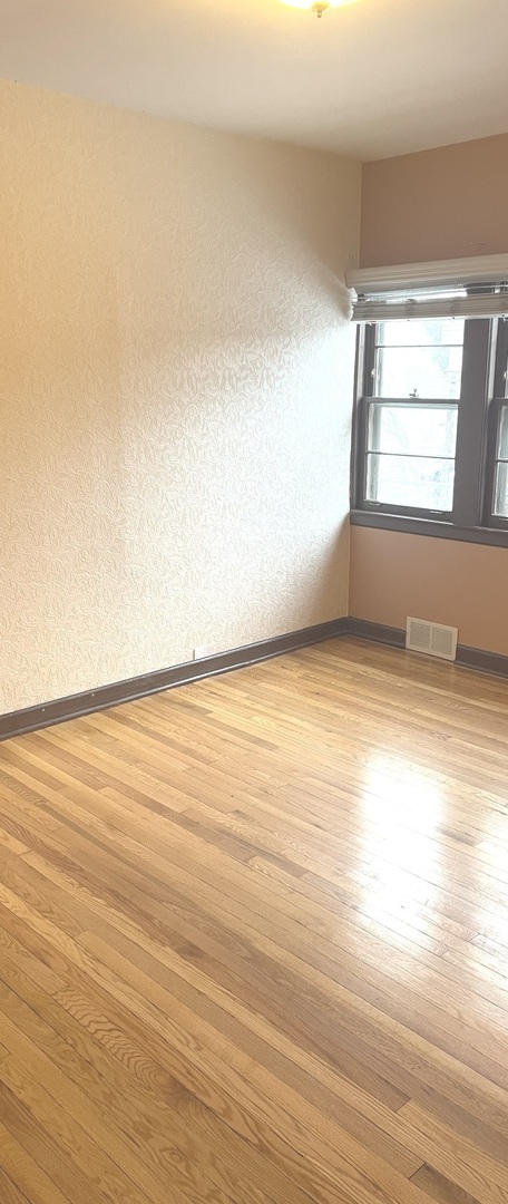 Undisclosed Address La Grange Park, IL 60526 - Photo 12 of 15 wooden floor in an empty room with a window