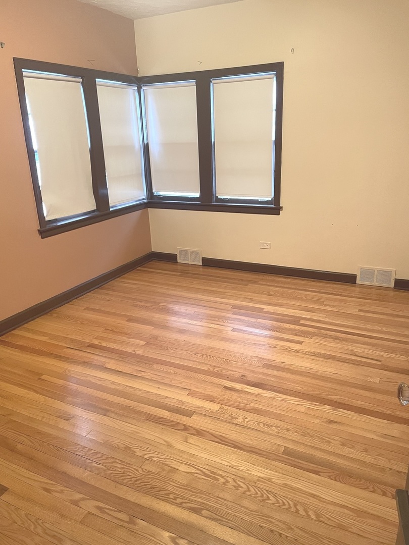 Undisclosed Address La Grange Park, IL 60526 - Photo 13 of 15 a view of an empty room with wooden floor and a window