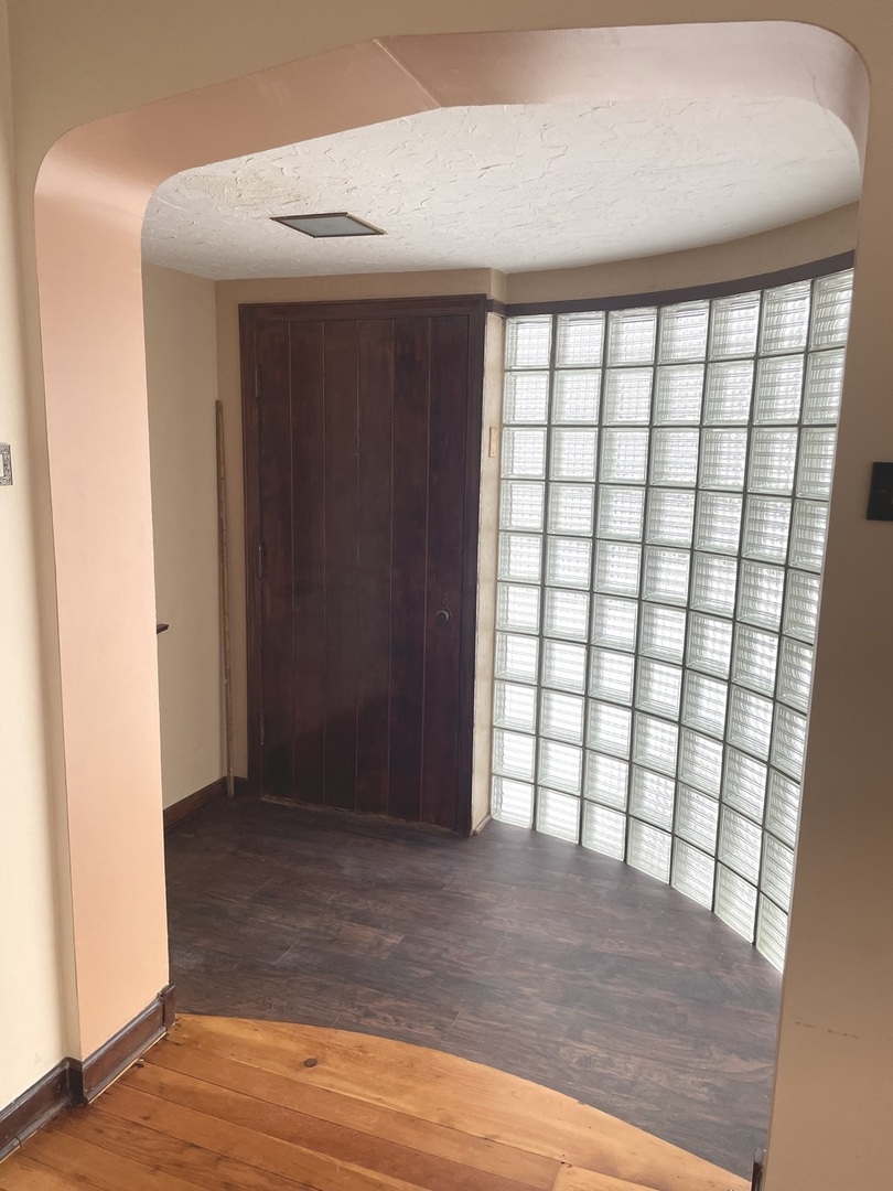 Undisclosed Address La Grange Park, IL 60526 - Photo 2 of 15 an empty room with wooden floor and windows