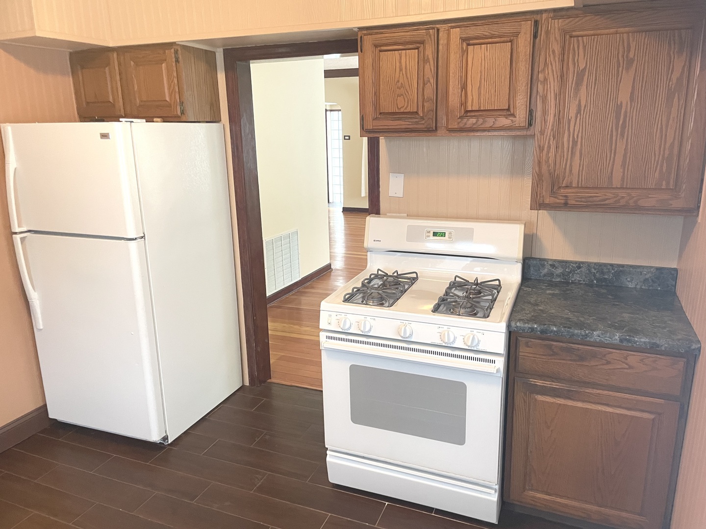 Undisclosed Address La Grange Park, IL 60526 - Photo 9 of 15 a white refrigerator freezer and a stove sitting inside of a kitchen