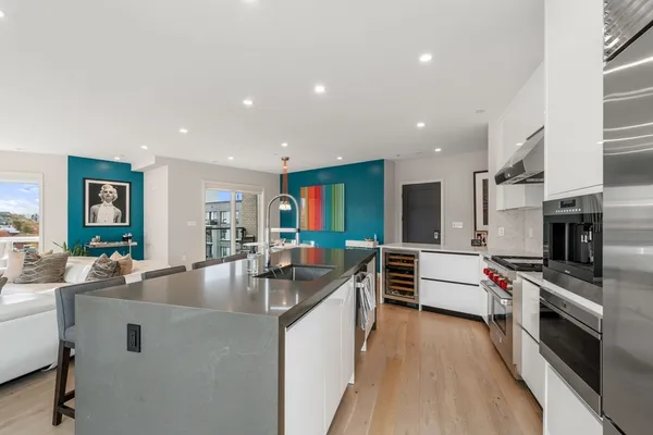 a large kitchen with stainless steel appliances lots of counter space and a sink