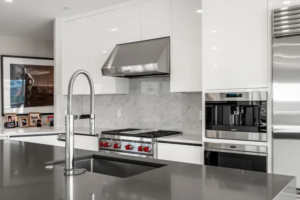 a kitchen with stainless steel appliances a stove and a sink
