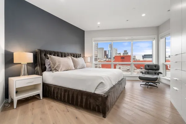 a bedroom with bed chair and window