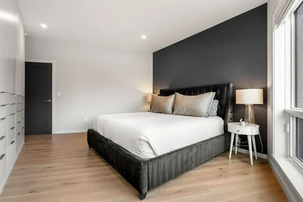 a bedroom with a bed and a lamp