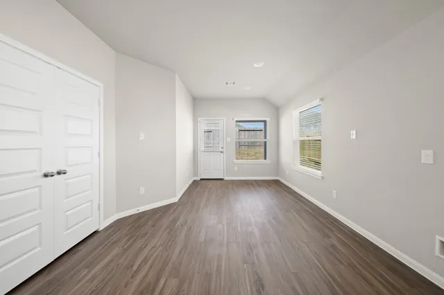 wooden floor in an empty room with a window