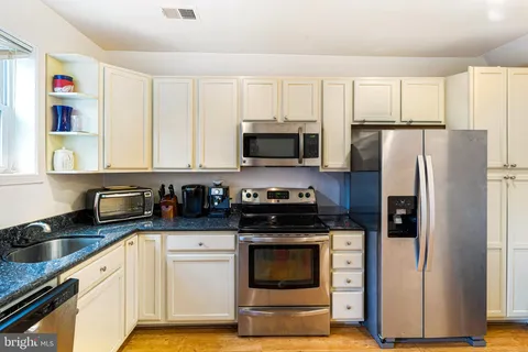a kitchen with a refrigerator stove and microwave