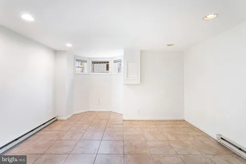 a kitchen with kitchen island a counter top space cabinets and stainless steel appliances