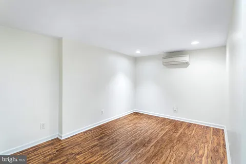 a view of room with wooden floor and fan