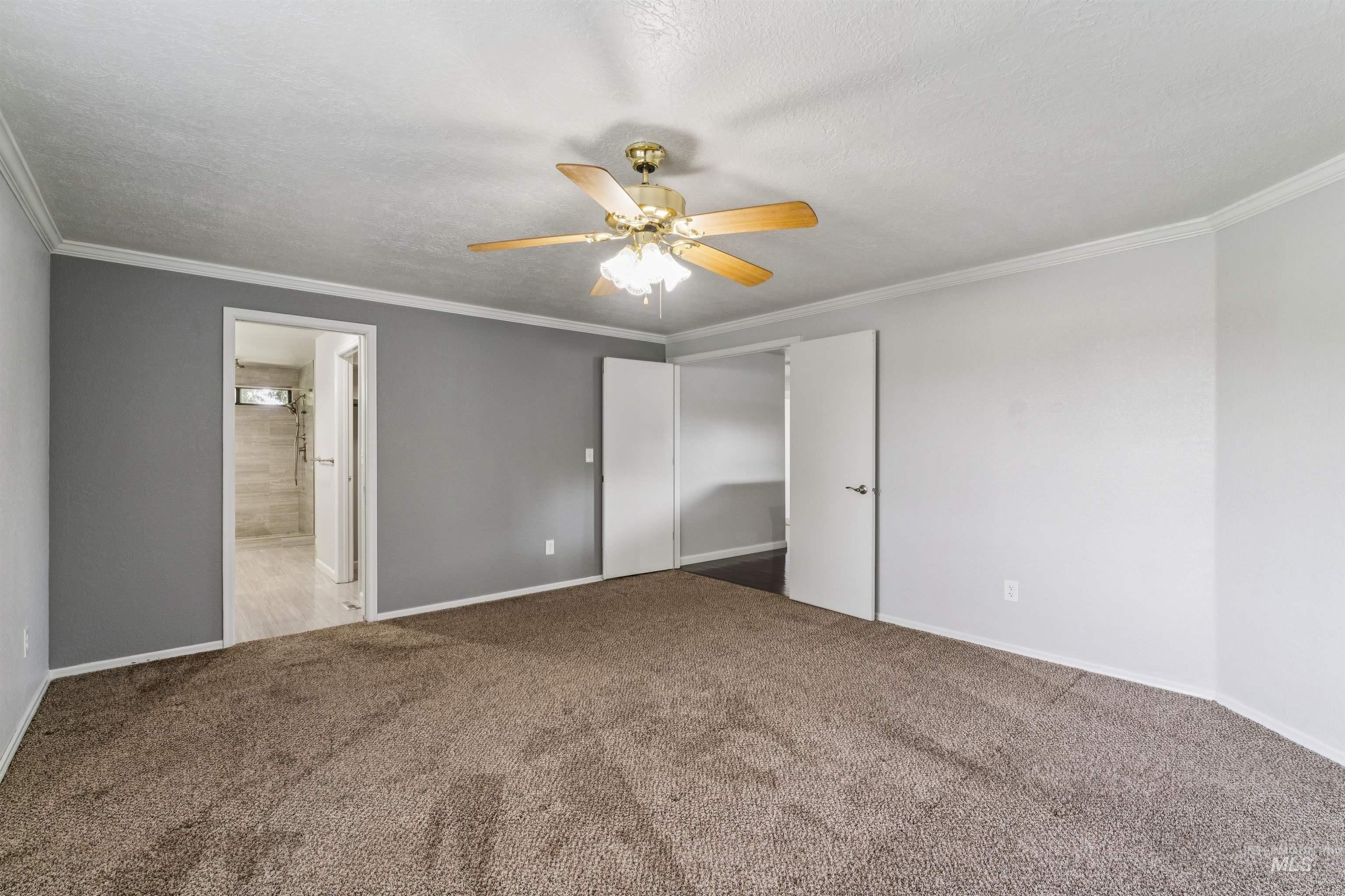 9831 West Ripley Street Boise, ID 83704 - Photo 23 of 47 Walk-in shower featuring light gray stone-look wall tiling, a mosaic tile floor, and a built-in window