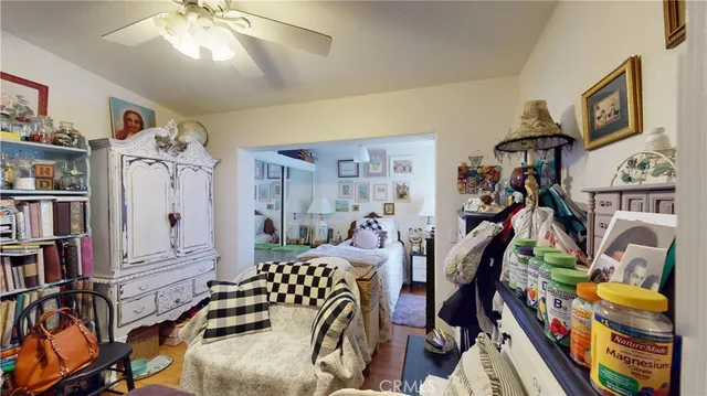 a bedroom with furniture and a large window