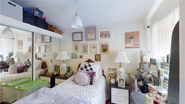 a room that has a bed and a mirror in it