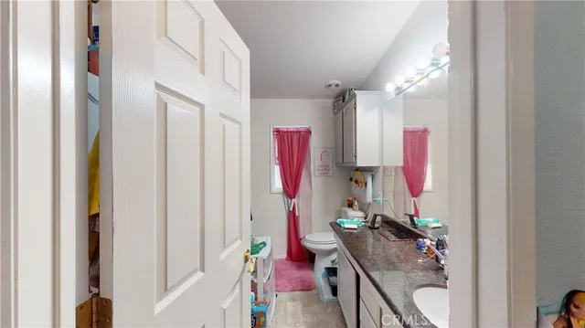 a bathroom with a sink mirror and toilet