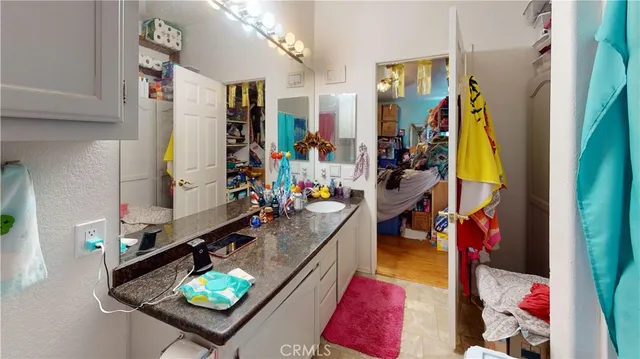 a bathroom with a granite countertop sink a toilet and shower