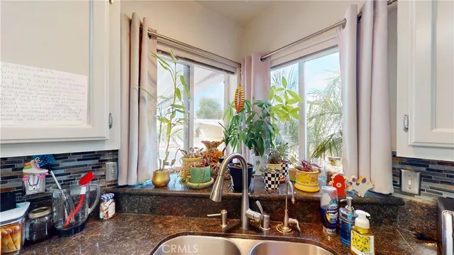 a room with musical instrument pool table and windows