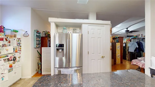 a view of a hallway with closet and furniture