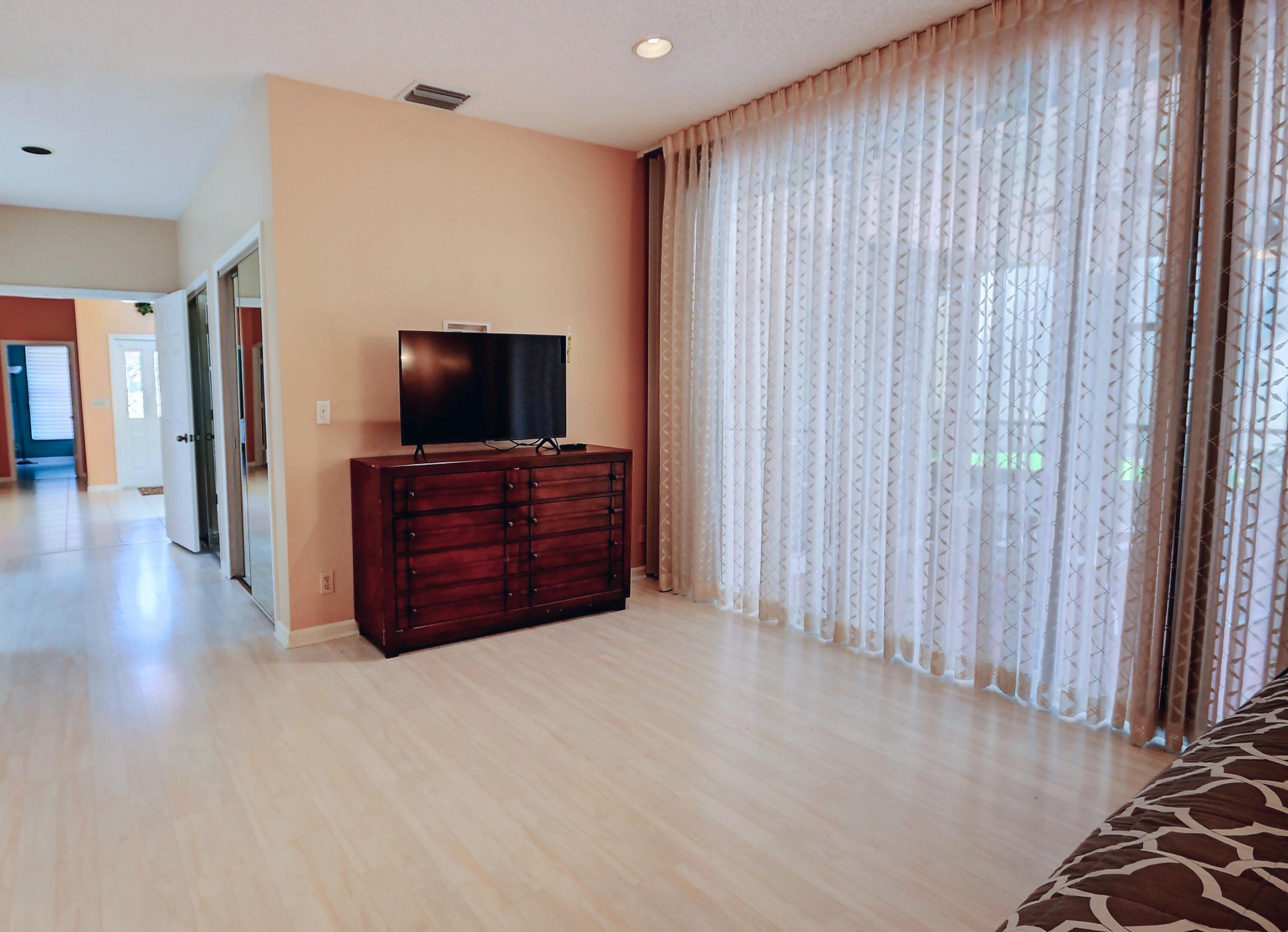 19356 Cherry Hills Terrace Boca Raton, FL 33498 - Photo 11 of 22 a living room with furniture and a flat screen tv
