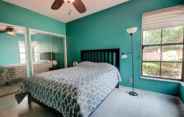 a bed sitting in a bedroom next to a window