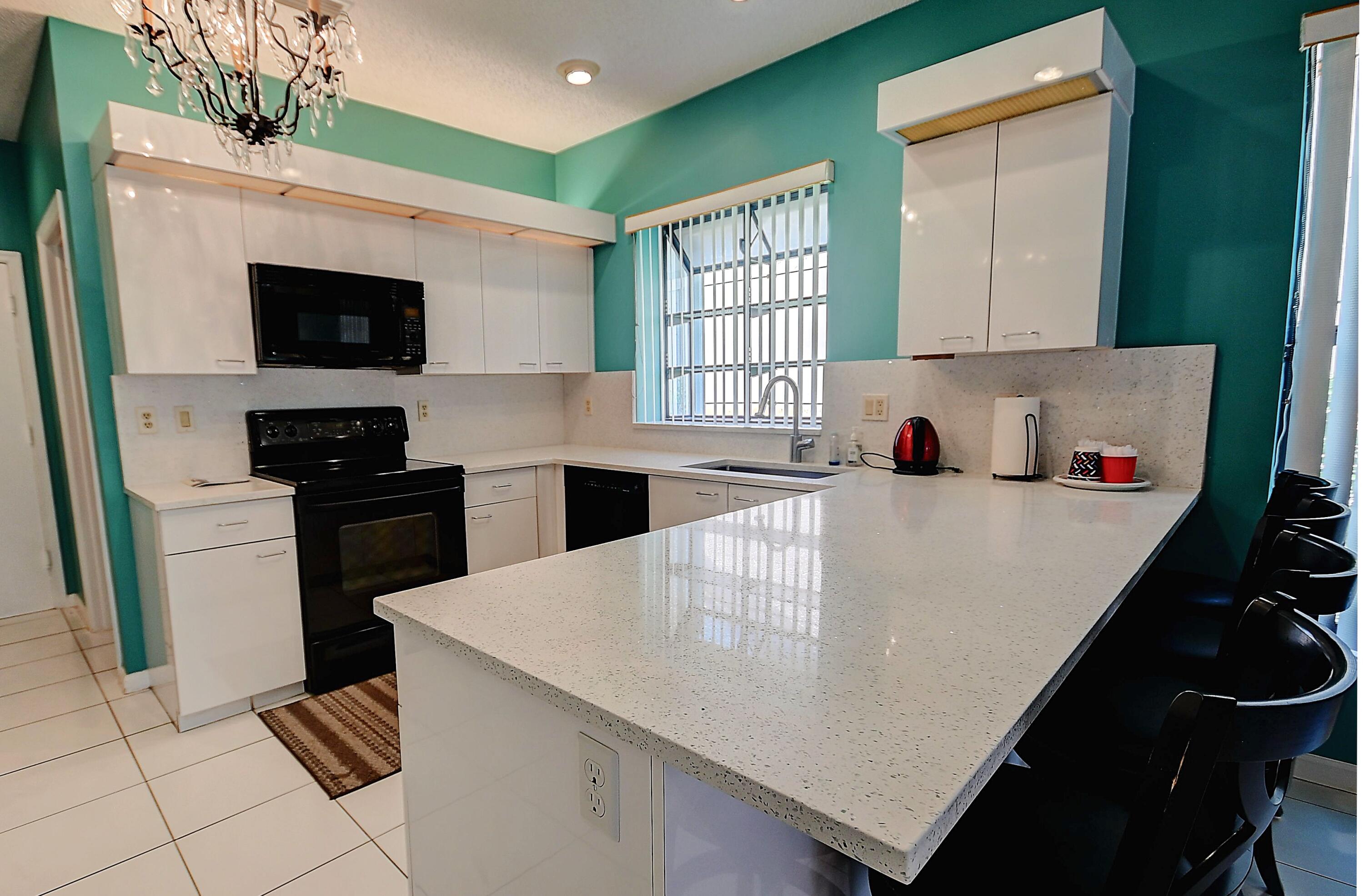 19356 Cherry Hills Terrace Boca Raton, FL 33498 - Photo 2 of 22 a kitchen with a sink a stove and refrigerator