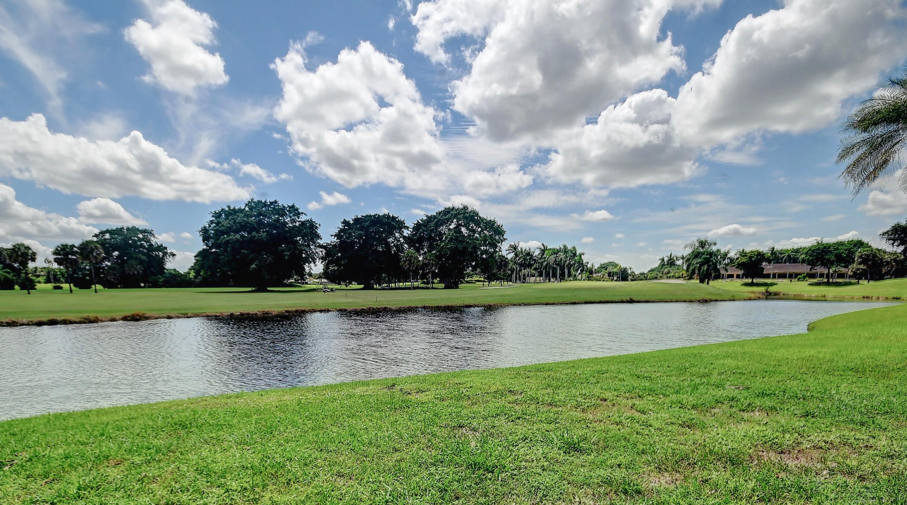 19356 Cherry Hills Terrace Boca Raton, FL 33498 - Photo 21 of 22 an aerial view of a house with a yard and lake in the background