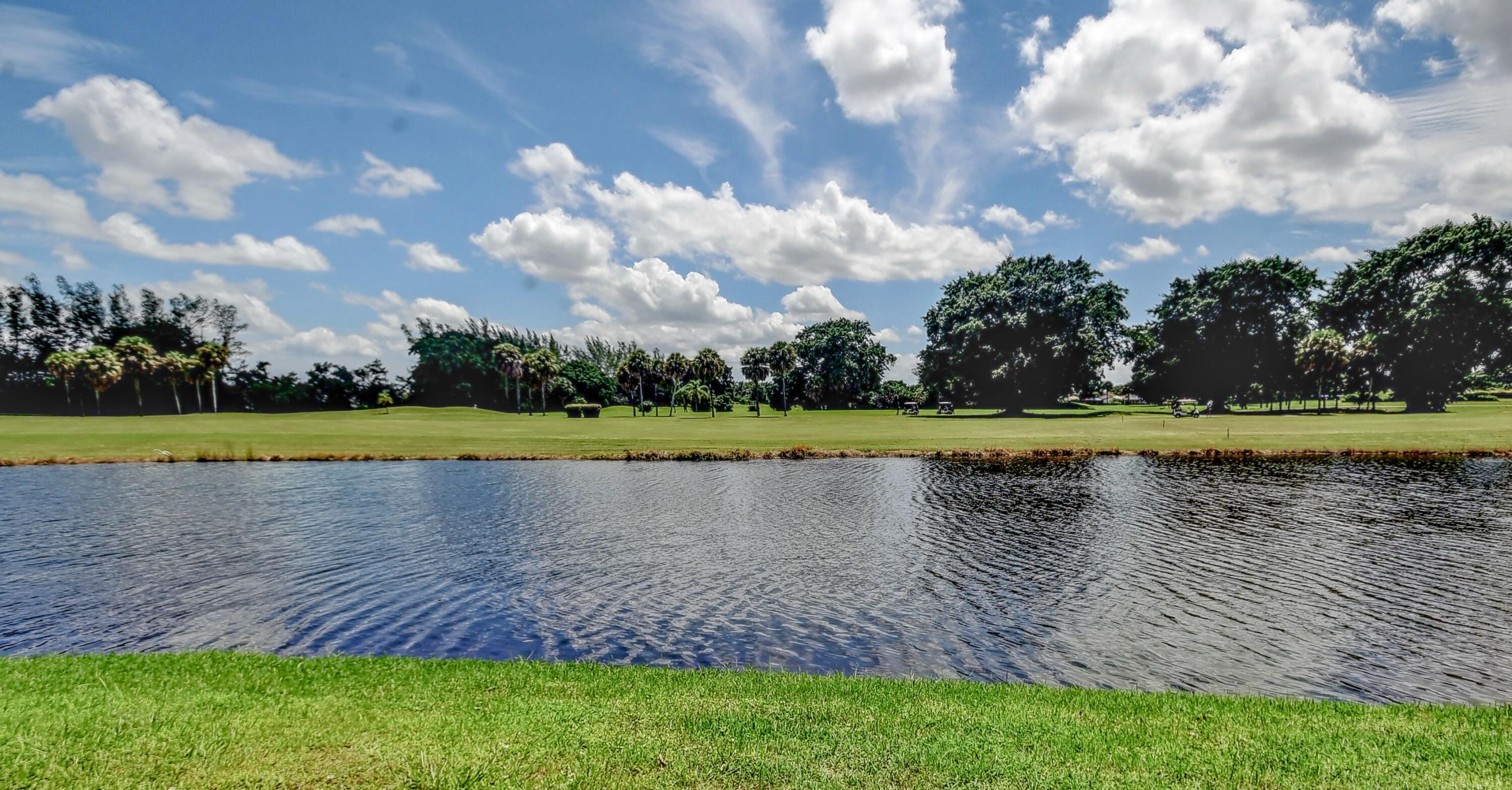 19356 Cherry Hills Terrace Boca Raton, FL 33498 - Photo 22 of 22 a view of a swimming swimming pool and a yard